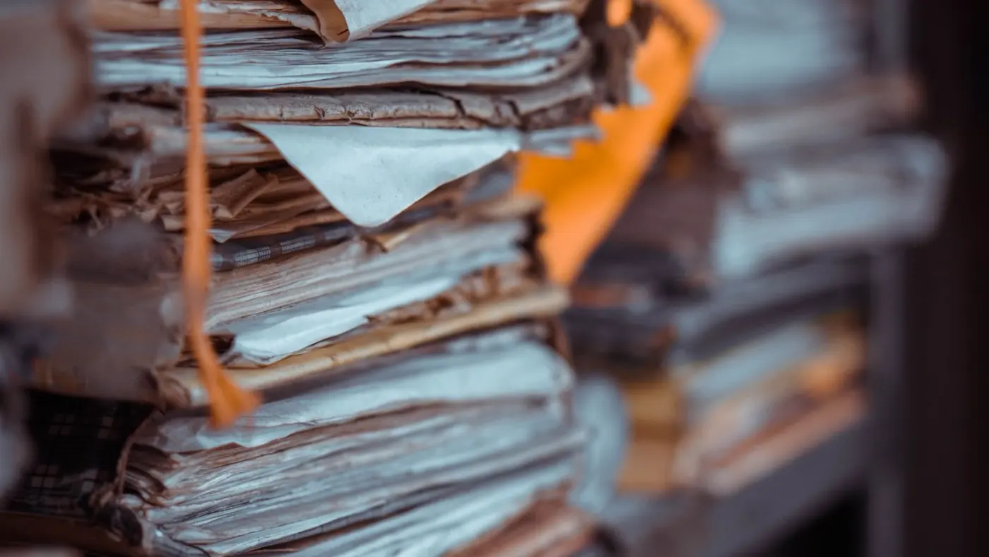 Stacks of paper records on archive shelving