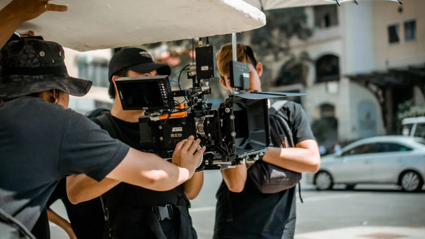 A film crew operating a cinema camera on location