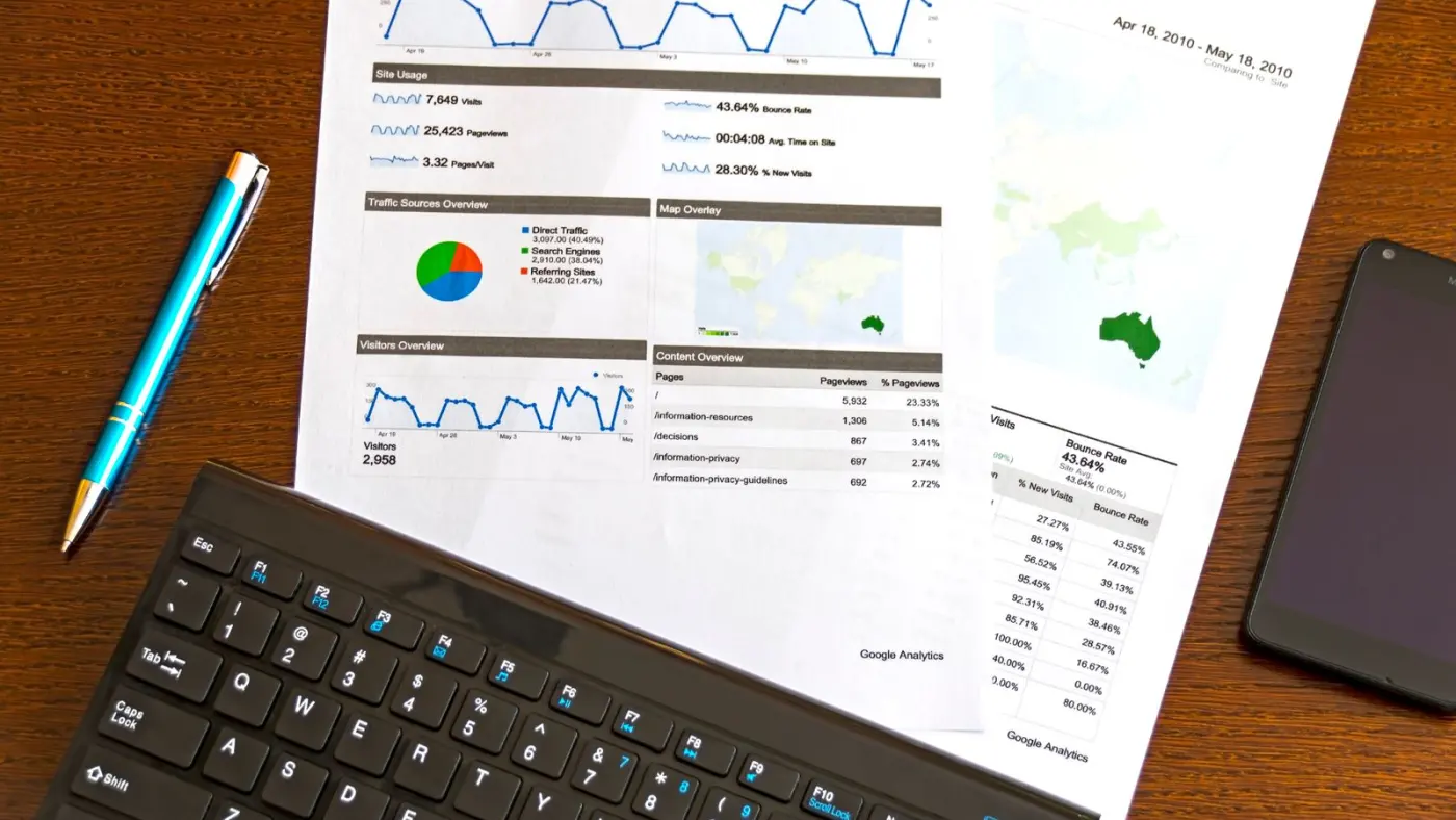 A printed analytics report on a desk beside a keyboard